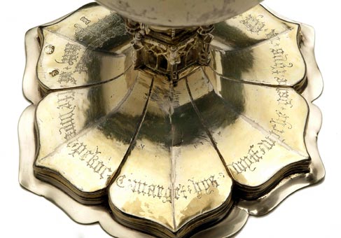 Close-up photograph of the chalice base from above. It is six-sided. Each side is shaped like a petal with a central point.