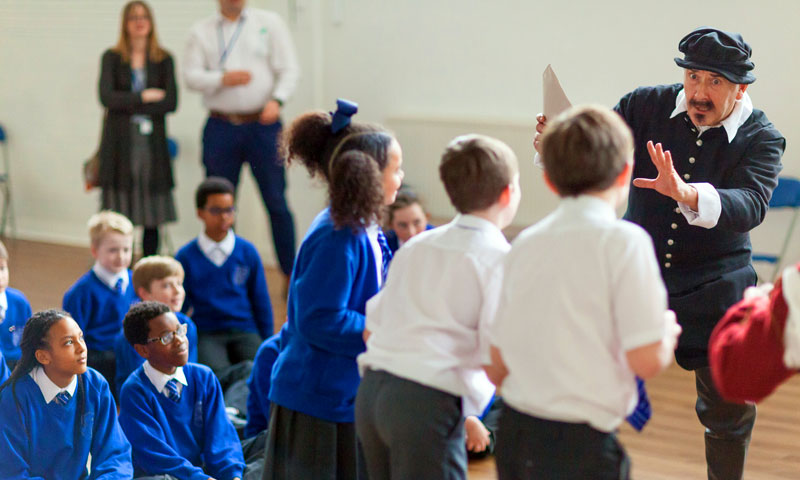 An actor in a school hall during a performance of an 'at your school' show.