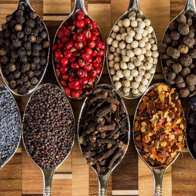 An animated GIF showing lots of spices on spoons.