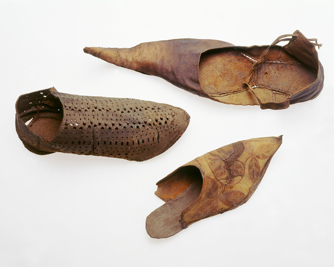 Selection of medieval leather shoes, including one with a very strong point.