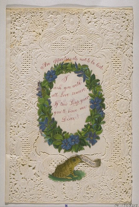 Valentine's card of white lace paper with embossed flower decoration and central white panel on which is handwritten 'An opportunity not to be lost. I ask you with all love sincere If this leap Year you'll have me dear'. 