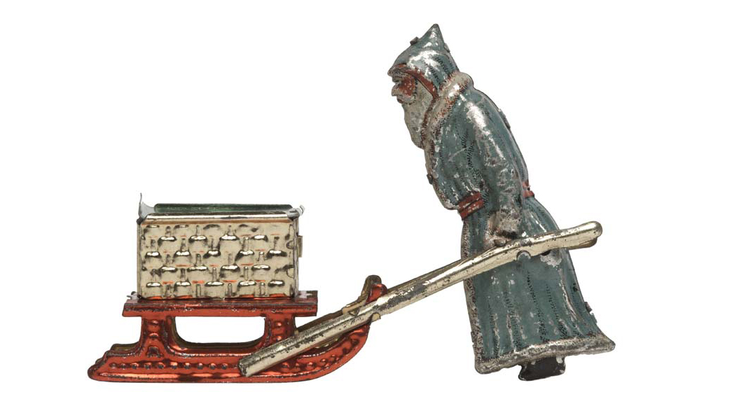 Mechanical lithographed tinplate penny toy Santa Claus and sleigh with candy container. Comprising a lithographed Santa Claus with white beard in grey fur-edged robe. 