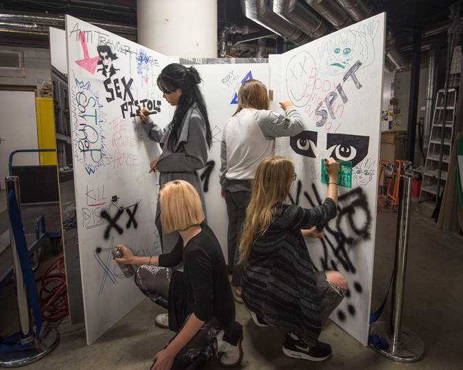 Students from Central Saint Martins decorate a set for the Being Punk Show Space.