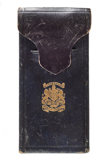 Bookshaped, expanding case of dark blue leather. Decorated with gilt. Brass clasp. Opens to reveal two daguerreotypes and pair of binoculars. Case lined with purple velvet. Leather spine broken. One picture speckled with black.