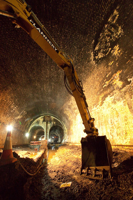A digger excavating debris from a tunnel as part of the Crossrail project.