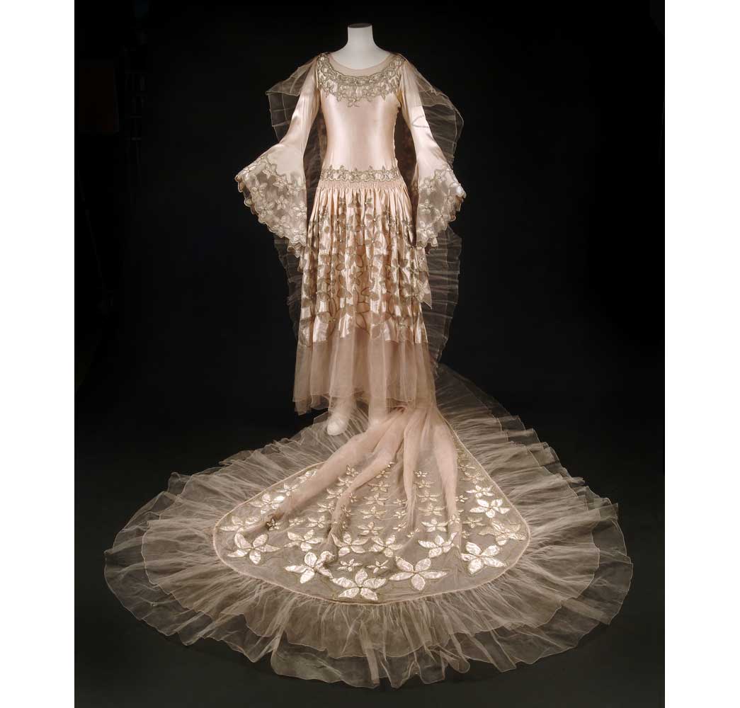 This spectacular dress was worn by Mrs Carl Bendix, later Viscountess Allenby of Megido, at the Dream of Fair Women Ball held at Claridge's Hotel in February 1928. The Ball's theme was 'women of the past, present and future' and this dress represented the present. The dress was given to the London Museum after the ball to be 'exhibited after 1960 as a perfect specimen of our quaint period'. 