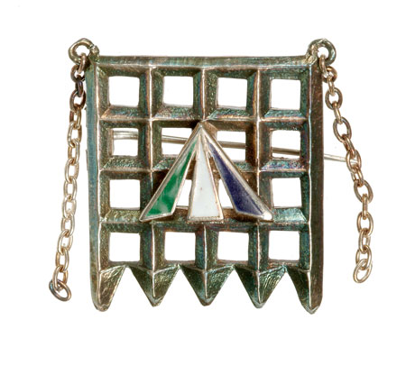 Designed by Sylvia Pankhurst, this silver Holloway brooch incorporates a silver portcullis, representing parliament, with a central, enamel convict's arrow in the suffragette colours of purple, white and green. The brooch was awarded by the Women's Social and Political Union to members who served a period of imprisonment for their militant suffragette activity.


