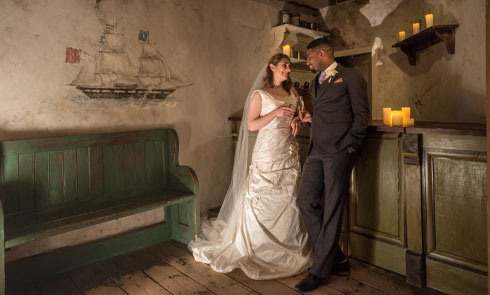 bride and groom pose in the museum of london docklands