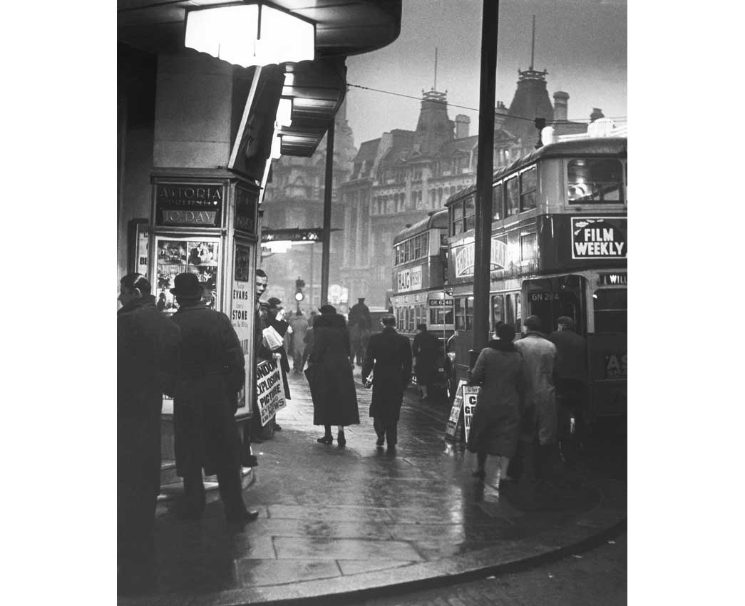 Charing Cross Road, c. 1935. Evening street scene outside Foyles book shop. Charing Cross Road is renowned for its specialist and second-hand bookshops. Suschitzky was attracted by the extensive array of second-hand bookshops and teahouses, and the crowds that flocked to them. The resulting series of photographs are amongst Suschitzky's most acclaimed work.