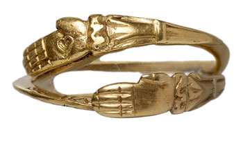 Beautiful image (Picturechase no 000742) of a post-medieval gold gimmel ring with interlocking gold hands and bezel. Shown closed. When open, the ring has an inscription that reads: 'As hands do shut soe hart be knit', reveling a secret shared by the wearer and her lover. 