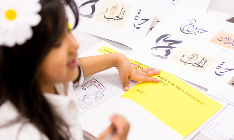A young student creates a museum-inspired artwork during a Museum of London supplementary school session.