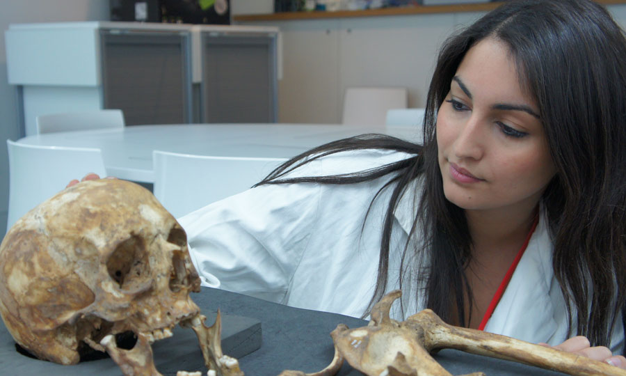 A student researches human remains at the Museum of London during a research placement.