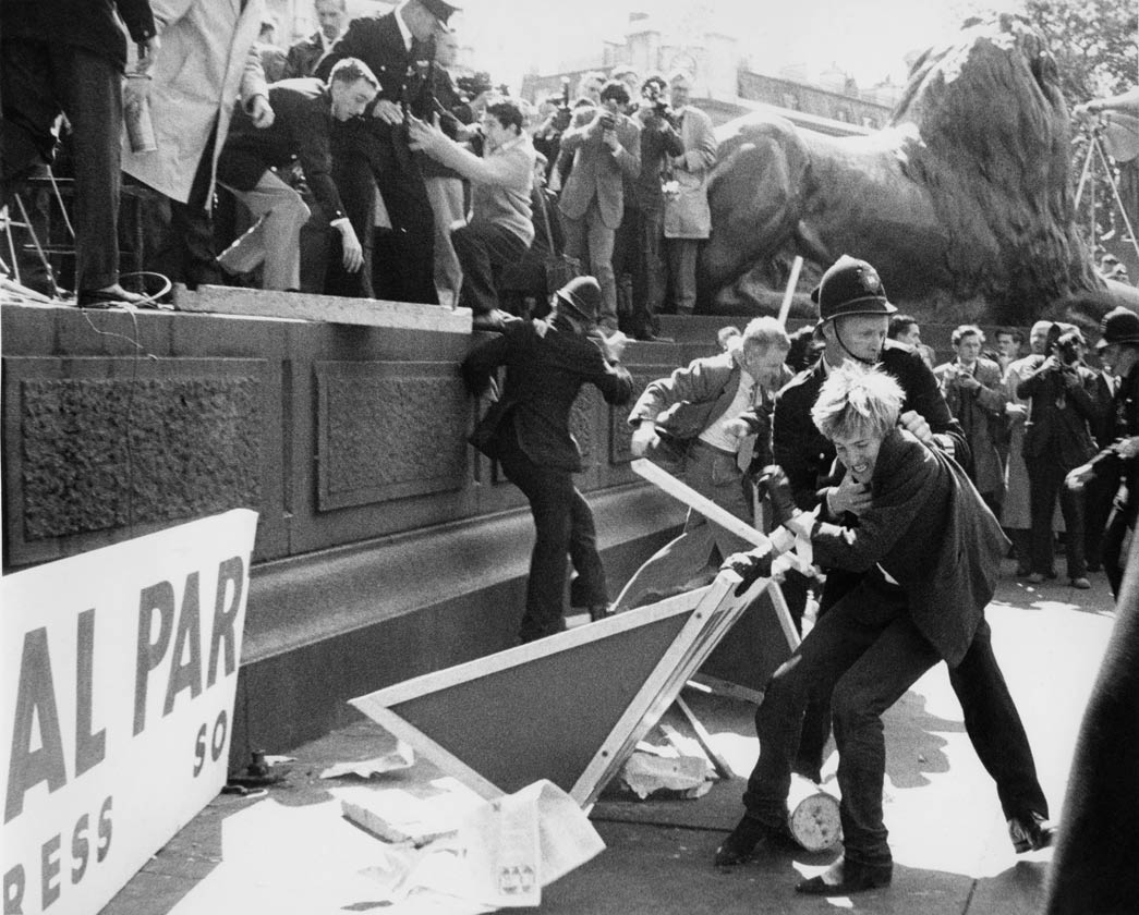 Clashes at a Mosley riot in Trafalgar Square between supporters, protestors and the police, c. 1960. Sir Oswald Mosley was a leader of the British fascist movement. A prominent figure before the Second World War, he stood at the 1959 general election for Kensington North, shortly after the 1958 Notting Hill race riots, and again at the 1966 general election, this time for Shoreditch and Finsbury. However, opposition to fascism was strong in post-war Britain and on both occasions he polled few votes.