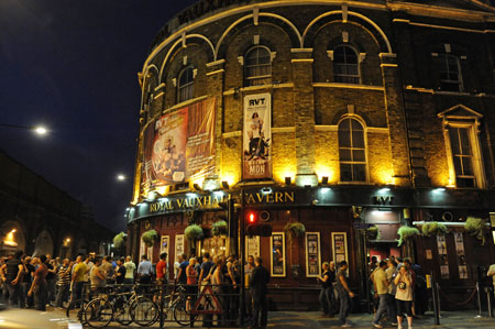 Royal Vauxhall Tavern is a traditional pub with regular club nights, such as Saturday's very popular Duckie. Between 1661 and 1859, the Vauxhall Pleasure Gardens was the biggest outdoor entertainment space in the UK, offering live concerts, opera, hot air balloons, tightrope walkers, bearded ladies, acrobats, wandering minstrels and massive firework Amongst the thronging crowds you could find Royalty, rogues, prostitutes and pickpockets. Luminaries such as Pepys, Dickens and Hogarth immortalised the place in writings and paintings but after their 18th century heyday the gardens fell into disrepair when the new railway line carved them in two and cut most of the Gardens off from the Thames. In 1863, 4 years after the whole site had been sold for a measly £800 the Royal Vauxhall Tavern was built. The RVT immediately became the focal point of the local working class community and music hall and variety acts from all over the country came to perform on it’s stage.
