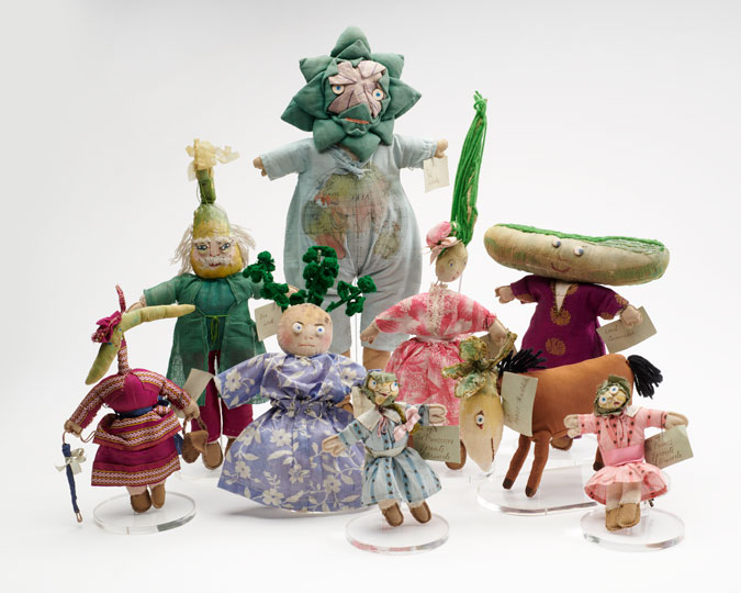Group shot of 9 of Una Maw's cloth vegetable dolls.