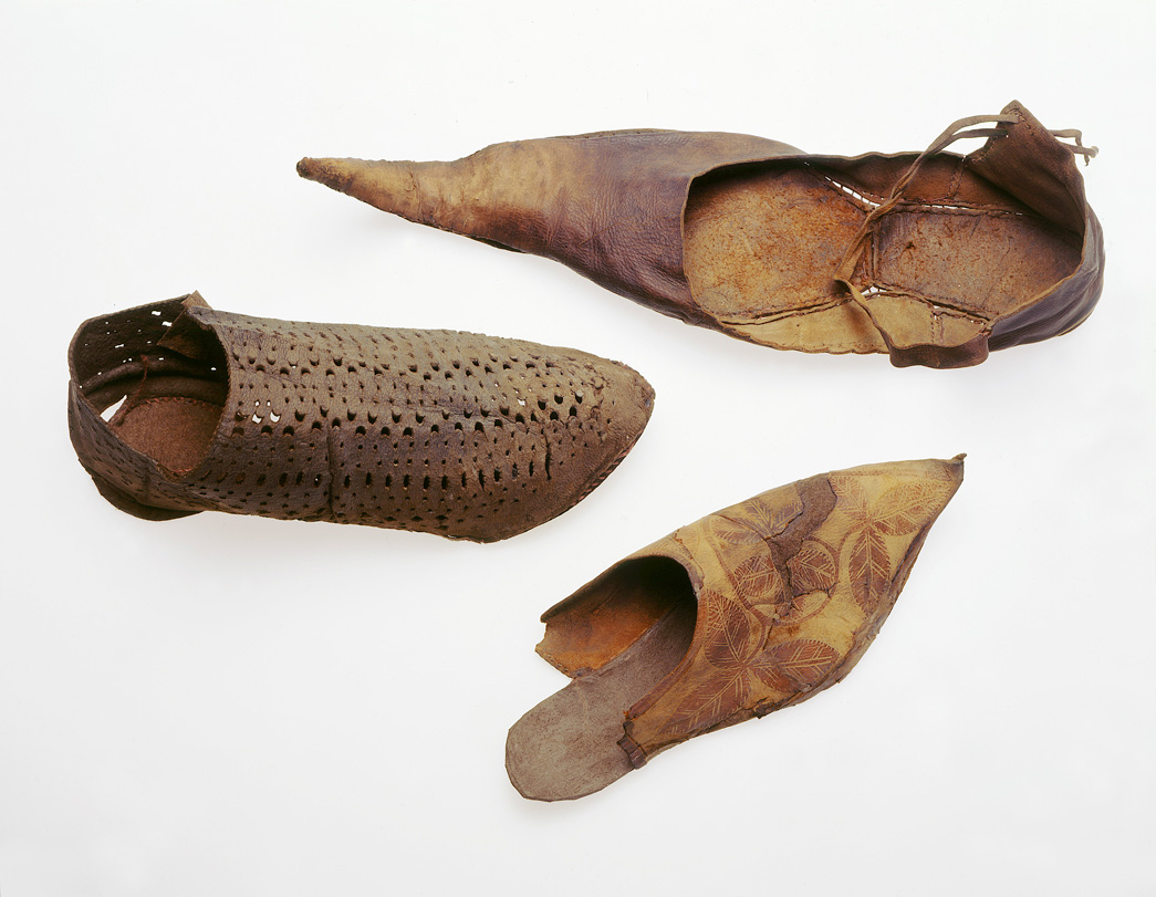 Several leather medieval shoes, some with long pointed toes.