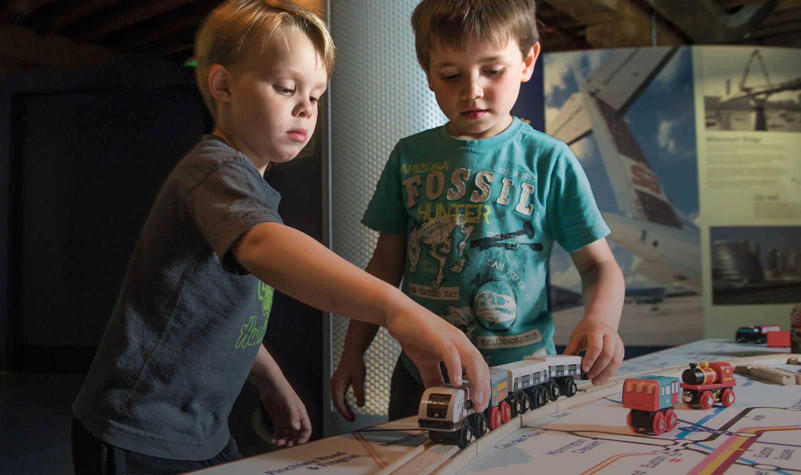 Two children playing with the train table at Museum of London Docklands