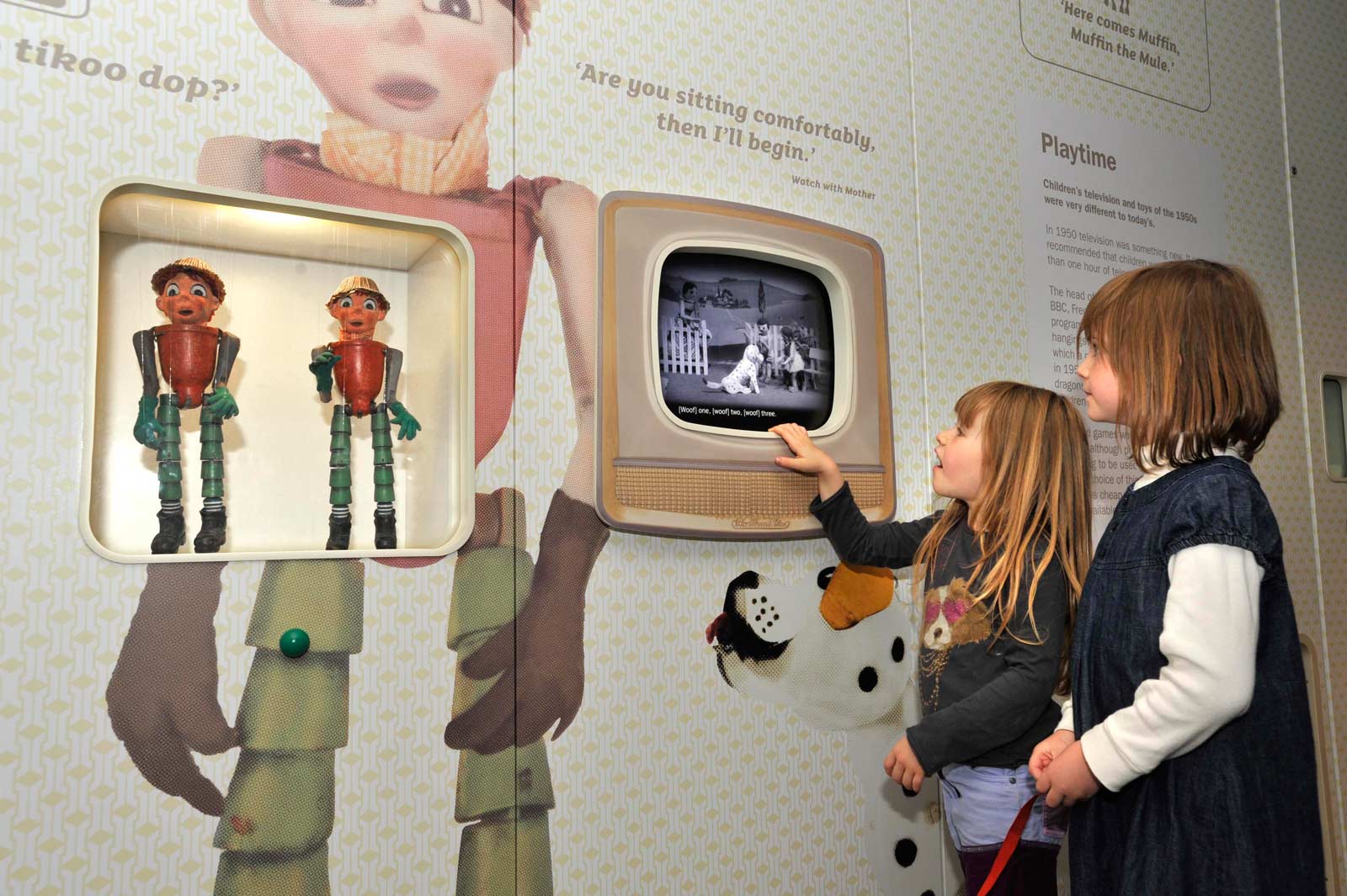 Children look at the Bill and Ben Flowerpot Men puppets on display in the World City gallery.