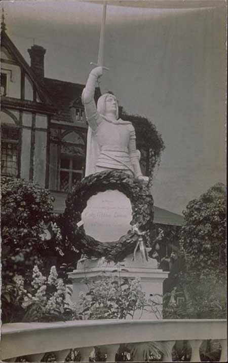 Postcard with photograph of a statue of Joan of Arc with a wreath on it, with the dedication 'In Honour and in Loving and Revered Memory of Emily Wilding Davison, She Died For Women'. During the 1913 Derby Davison ran out onto the racetrack in an attempt to stop the King's horse. She received serious head injuries and died 4 days later. The WSPU organised a spectacular funeral procession in her honour.