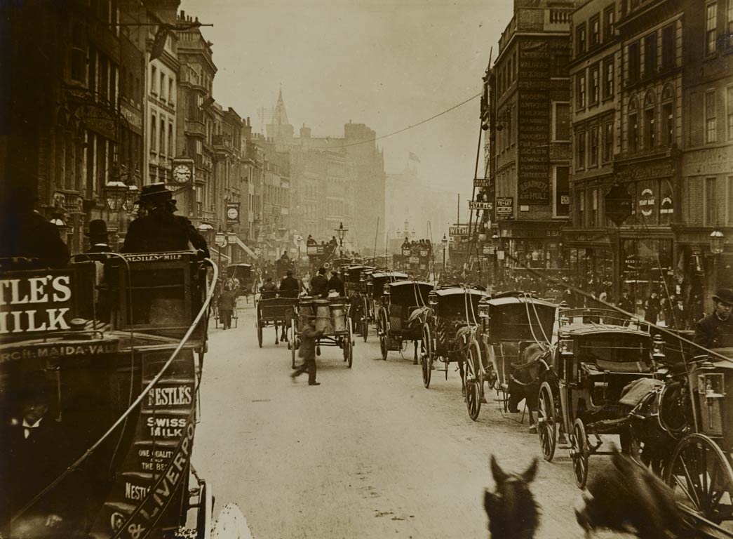 A view photographed from an omnibus on the move along High Holborn near Chancery Lane. The photograph captures a sense of the immediacy and hustle and bustle of traffic in central London at this time. 