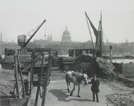 Greenmoor Wharf rubbish depot, Bankside. This Bankside wharf was the site of Southwark Corporation's rubbish depot when George Davison Reid took this photo. Refuse, transported by horse and cart, was loaded into barges using chutes and hydraulic cranes. Once laden, the barges would head downriver to the estuary. Horse manure would be separated out and used to fertilise agricultural land.
