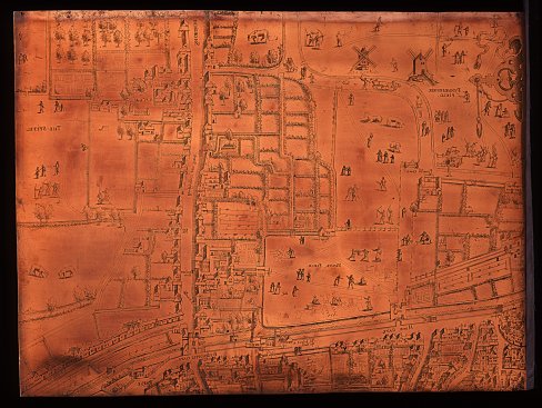 Photograph of a sheet of copper that has been etched with the map of London. The design is in reverse so that paper imprints come out correctly.