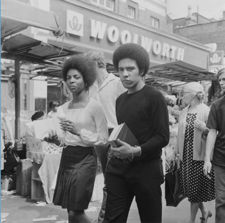 Young people walking through Camden in casual clothing, embracing their natural hair during the era of the Black power movement. Henry Grant. 1970 ID no. HG2652/12