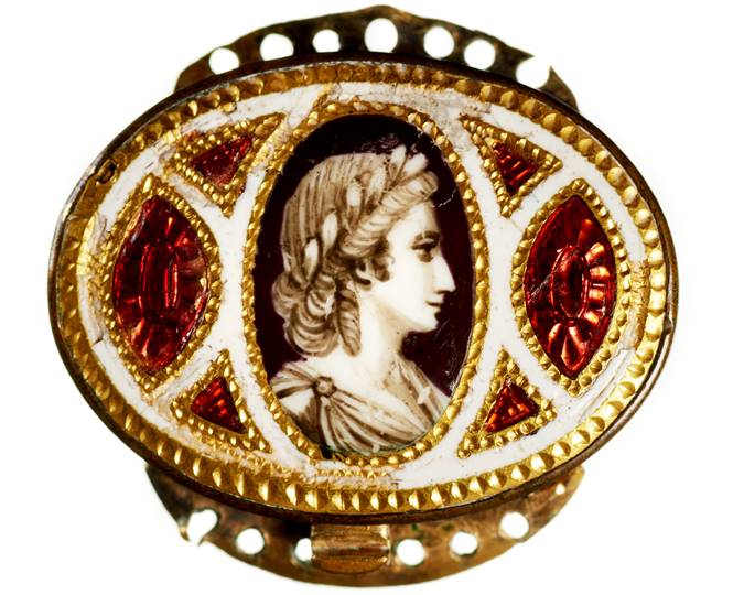A woman depicted as a Roman laureate female, possibly a Muse, on one of a pair of miniature bracelet plaques made of gold. It is possible that the 18th century recipient of the plaques was named after the Muse and that the figure depicted is a delicate reference to the classical antecedents of her name. (ID no.: C1705)