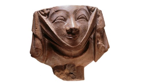 Medieval corbel, in the shape of the head of woman wearing a wimple - or neck cloth. The wimple was a very fashionable form of dress in medieval times. This carved head was part of a London building decoration. It was found at Temple Church, Fleet Street, London.