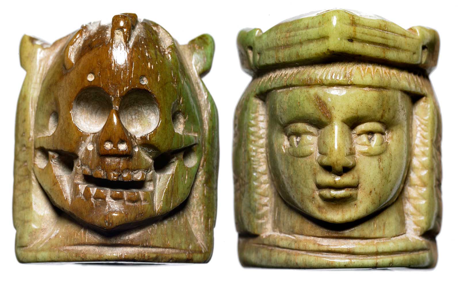Two sides of a medieval rosary bead, designed with a face on one side and a skull on the other.