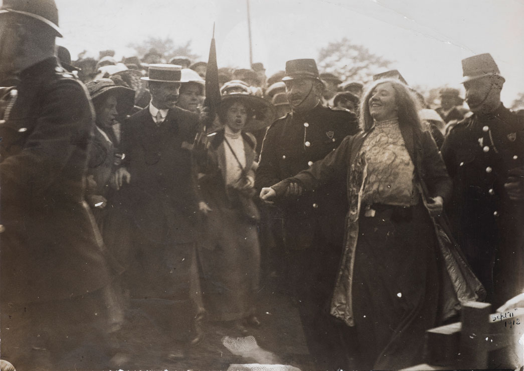 The Suffragette Kitty Marion arrested for heckling David Lloyd George to the Royal National Eisteddfod, Wrexham, Wales, Thursday September 5th 1912. Kitty Marion gained admission to the meeting with the sole aim of heckling Lloyd George. As a result of her action Marion was set upon by the crowd and 'received blows and abuse from every side, my hat being torn off and hair pulled down', as depicted in the image. During her subsequent imprisonment Marion complained in a letter to a fellow prisoner that her beautiful auburn hair was 'falling out dreadfully here' (in prison). Whilst she believed this was as a result of her treatment by the hostile 'mob' in Wrexham it is more likely the poor condition of her hair was due to her prison hunger-strike.