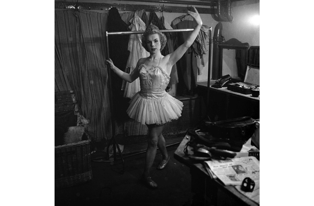 Bobbie Barlow in the dressing room, trying out a dance move, May 1954. post-WWII period 1950s’ drag shows. (©Alan Vines / Topfoto)