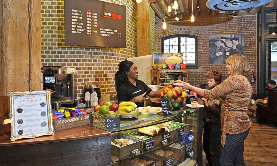 A woman and a child buying from the cafe at Museum of London Docklands