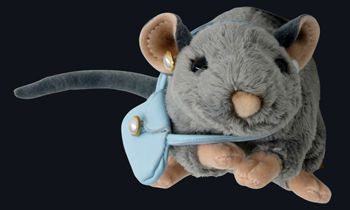 A photo of a cuddly toy rat with 1960s earrings and handbag.