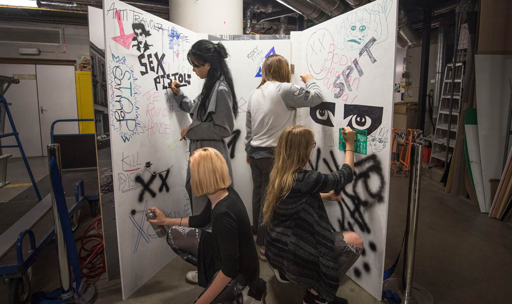 Students from Central Saint Martins decorate display for the Being Punk Show Space.