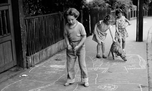 Girls playing hopscotch in the street. Henry Grant, c. 1955. ID number HG1609/45