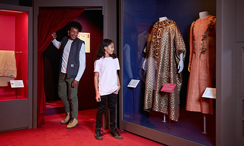 A child and guardian enjoying the Fashion City exhibition at Museum of London Docklands