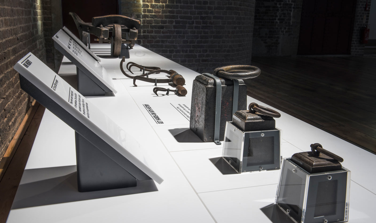 Interactive tables in the No. 1 Warehouse gallery showing weights, ropes and tools.