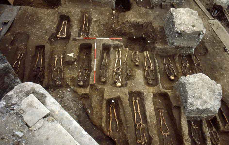East Smithfield Black Death burial ground, 1980s. The individual graves are shown being excavated by archaeologists.