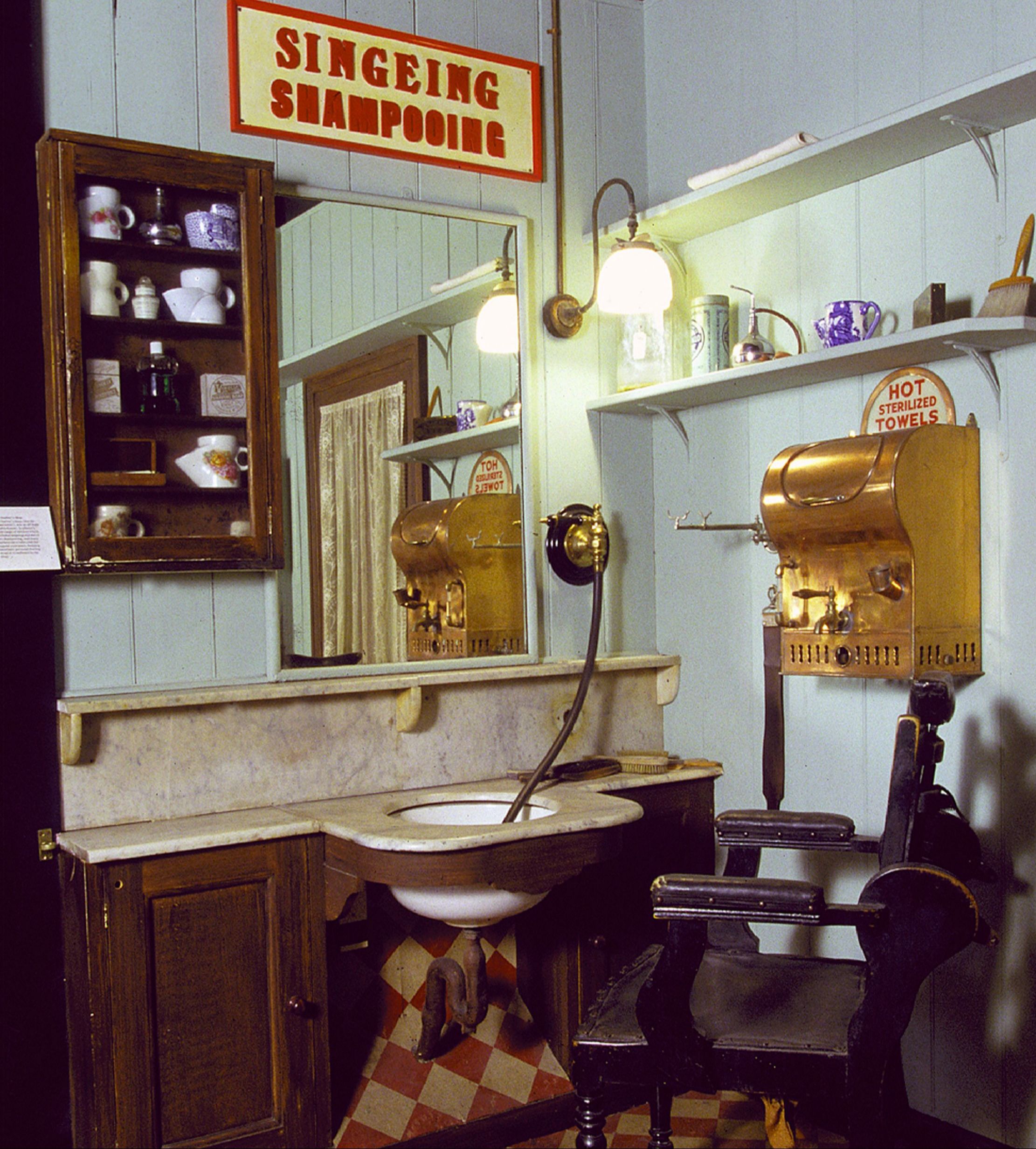 General view of a reconstruction of a Victorian barber shop. A barber services for men included haircuts, shaves and shampooing. Hair was also 'singed'.
