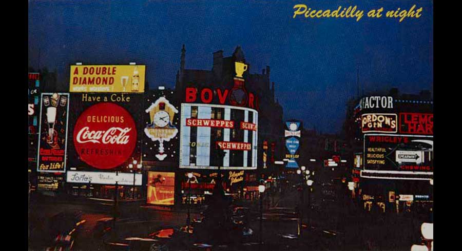 Postcard with a 1960s view of Piccadilly Circus at night - mid size