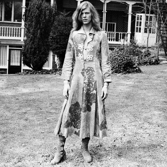 A black and white shot of David Bowie in a dress designed by fashion designer, Mr Fish