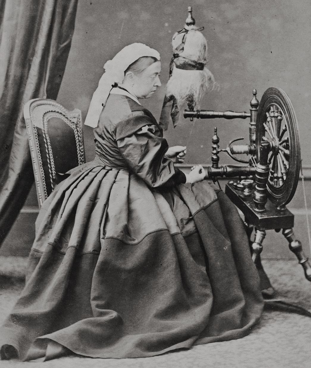 Queen Victoria at a spinning wheel, April 1865
Queen Victoria seated and holding thread which she spins on a spinning wheel. She mentions the photo being taken in her journal on 4 April 1865. (Courtesy Royal Collection Trust / © His Majesty King Charles III 2023)
