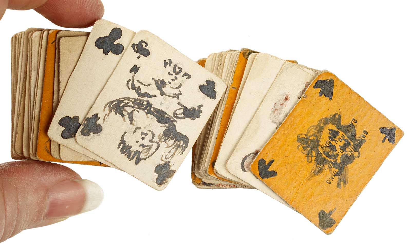 ​Playing cards made by the suffragette Kitty Marshall held between fingers - hero image