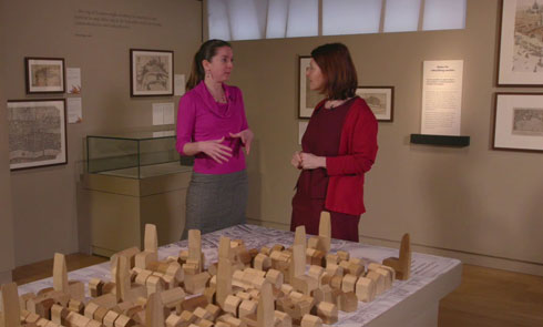 Meriel and Nina discuss the rebuilding of London above a large wooden diorama of the city.
