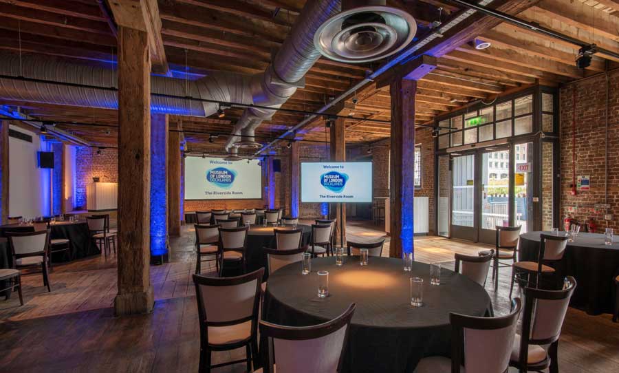 Chairs, tables and projectors sit ready for an event in this stunning, historical space.