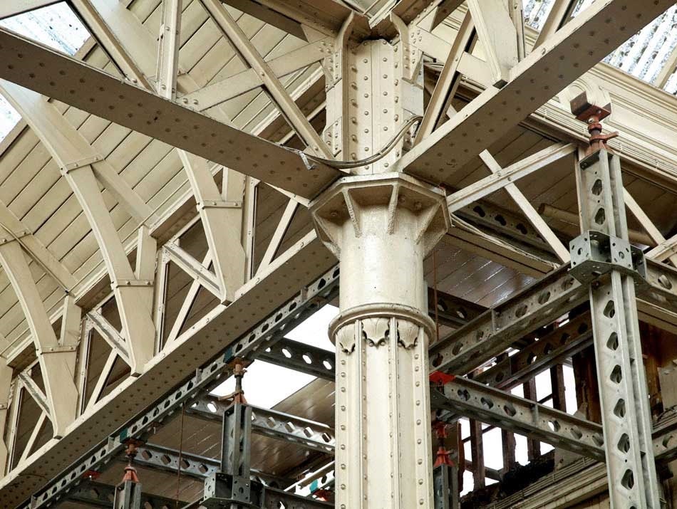 Photo of a rusty, metal and a phoenix column within Smithfield market.
