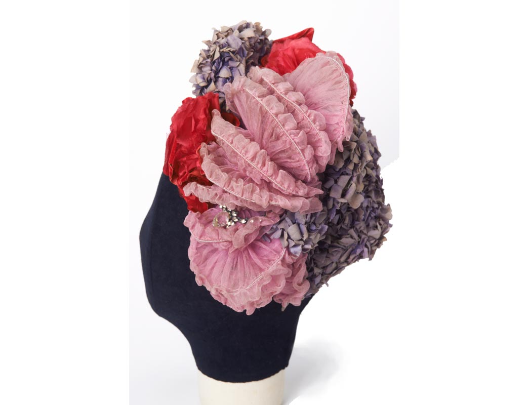 Headdress decorated with artificial flowers.