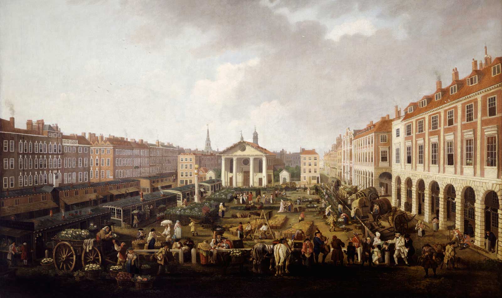 Covent Garden Piazza and Market. Oil on canvas. View from the east side looking towards St. Paul's church and Covent Garden. The scene shows a full range of sheds and two-storeyed market buildings. A number of carts are lined along the roadway on the north side. Sedan chairs can be seen under the 'piazzas'. The figures in this scene include street musicians, pick-pockets and a chair mender. The Spire of St. Martin-in-the-Field can be seen in the distance.

