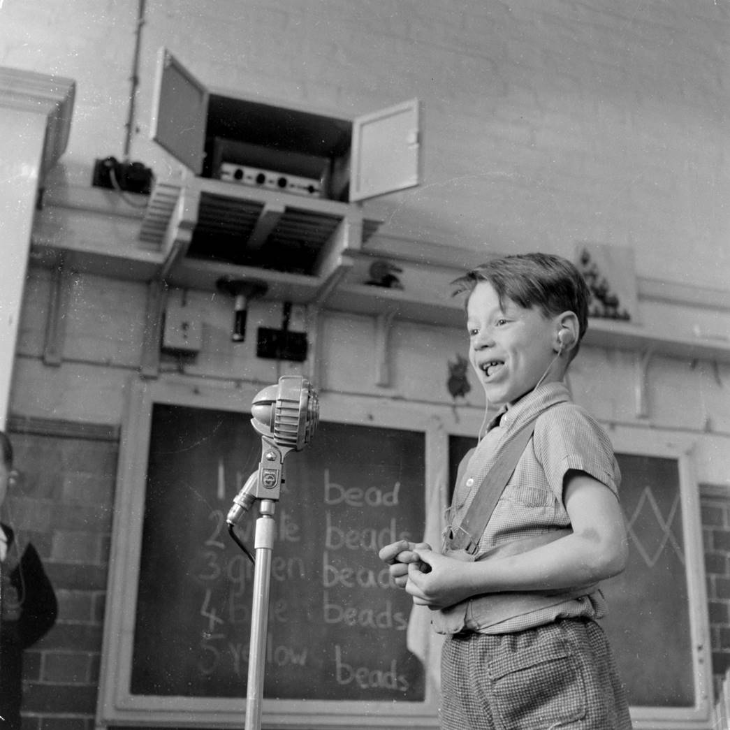 A child speaking into a microphone at the Ackmar School for Deaf Children, 1958. (ID no.: HG1827/24, ©Henry Grant Collection/Museum of London)
